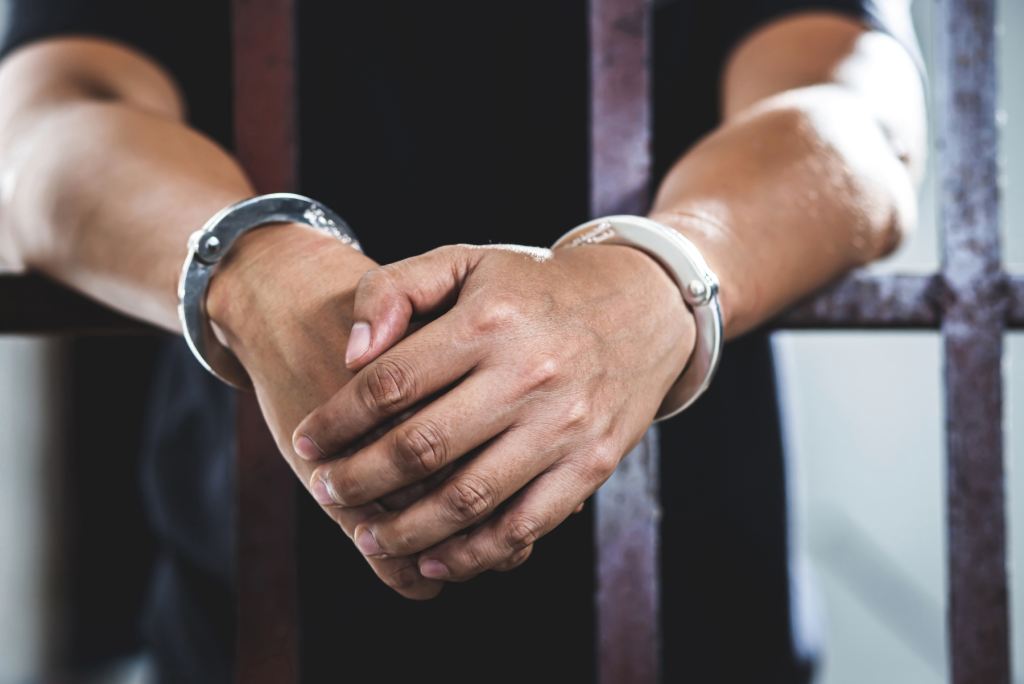Image of someone in a jail cell, Issa Castro Law Firm.
