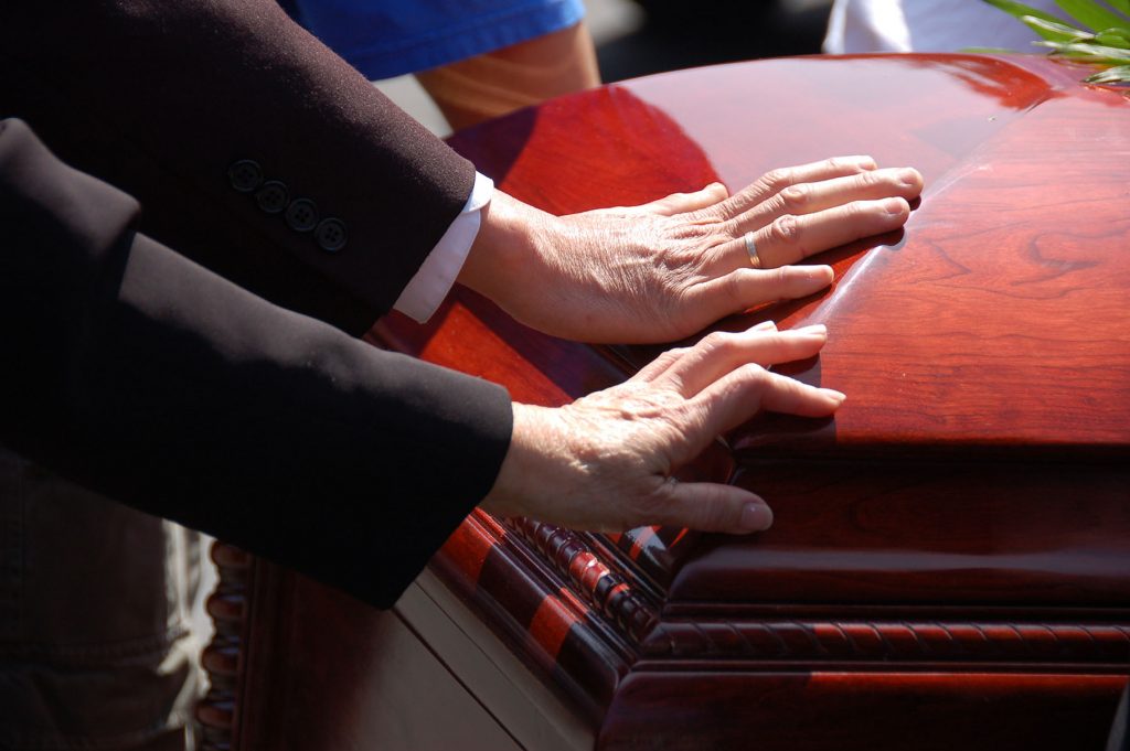 Image of a casket at a funeral, Issa Castro Law Firm.