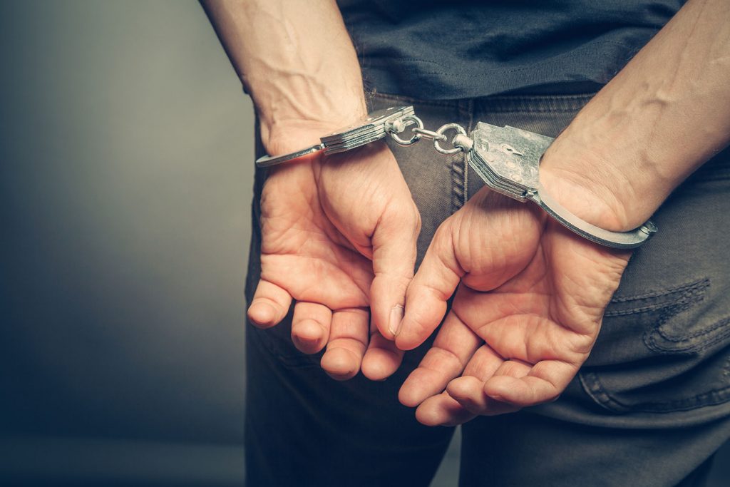 Image of someone in handcuffs, Issa Castro Law Firm.