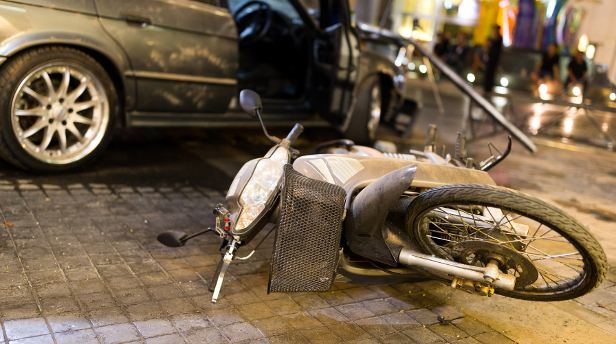 Image of a motorcycle on the road that has been wrecked, Issa Castro Law Firm.