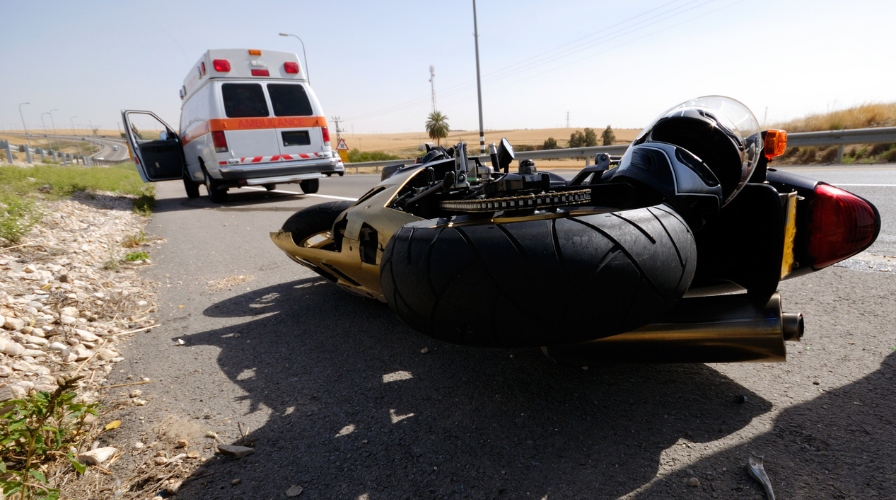 Image of a motorcycle on the road that has been wrecked, Issa Castro Law Firm.