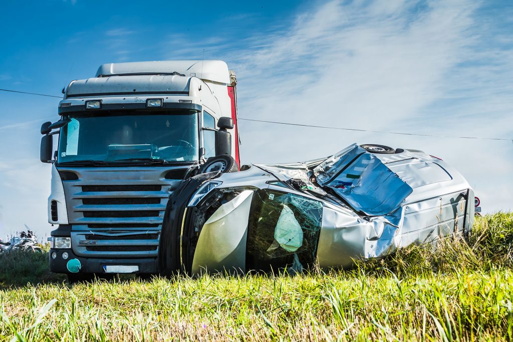 Car accident on a road in September, car after a collision with Car accident on a road in September, car after a collision with a heavy truck, transportation background