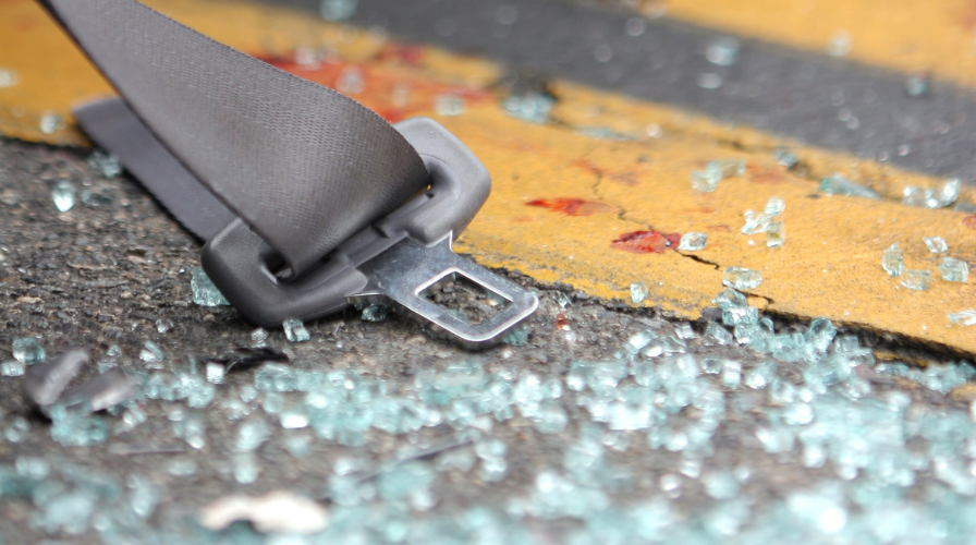 Image of a seat belt and broken glass on the highway, Issa Castro Law Firm.
