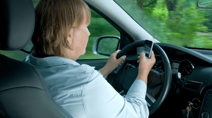 Driving while texting Image of a driver on their phone for distracted driving accidents, Issa Castro Law Firm.