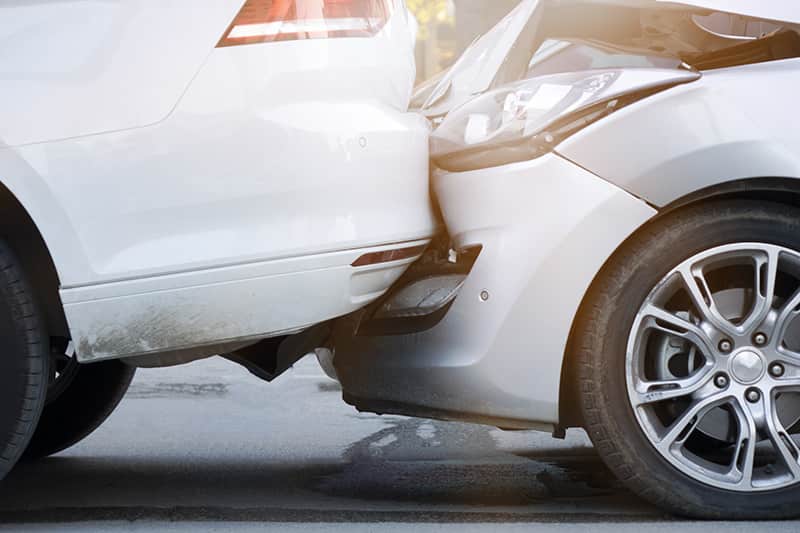 Auto accident involving two cars on a city street Image of an auto accident for an auto accident legal case. Issa Castro Law Firm