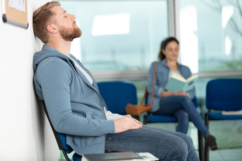 man sitting in doctors waiting room