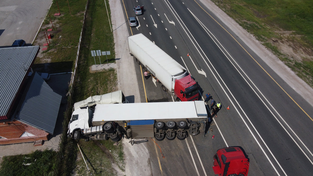 Top view of a car accident involving a truck and a bus. Filming from a drone.