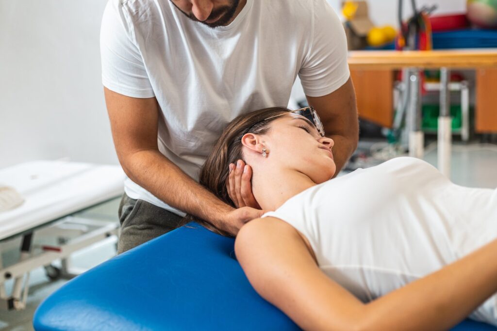 Person receiving chiropractic neck care after a car accident